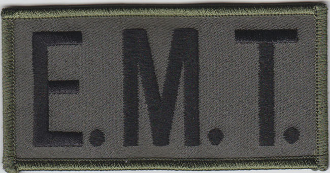 E.M.T. Black on OD Green Front Panel Patch 2X4