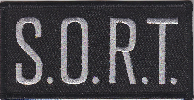 S.O.R.T. Grey on Black Front Panel Patch 2″ X 4″